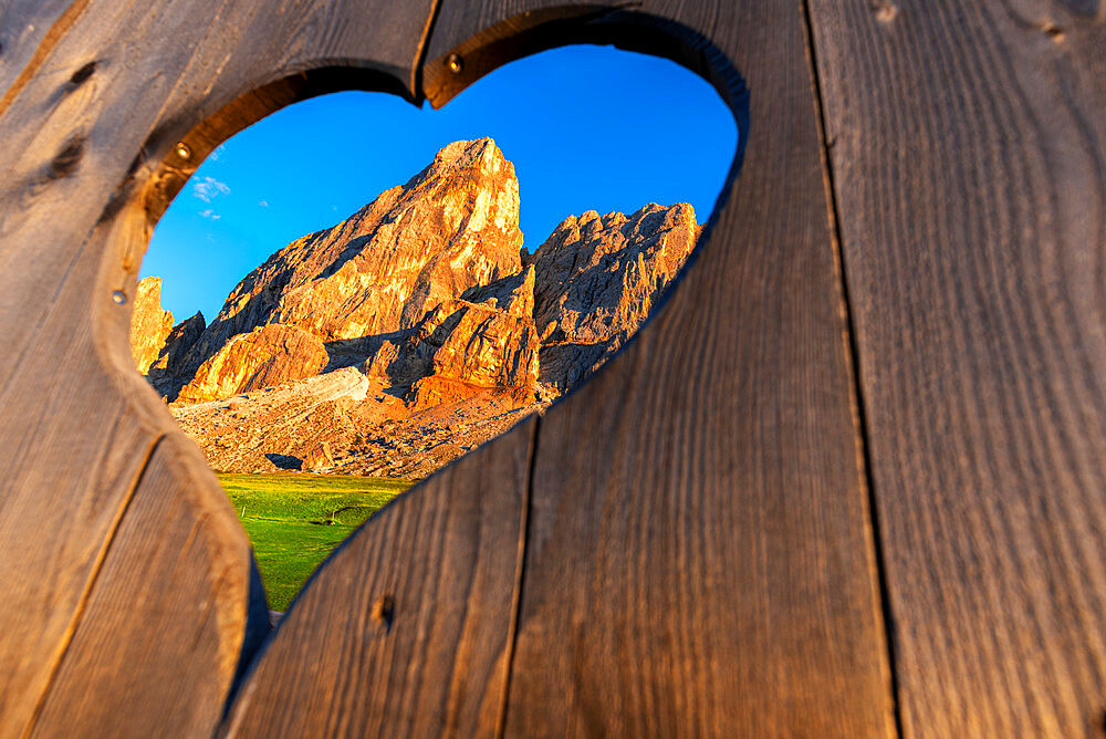 View of the Sass de Putia through a heart shaped hole at dusk, Passo delle Erbe, Dolomites, South Tyrol, Italy, Europe