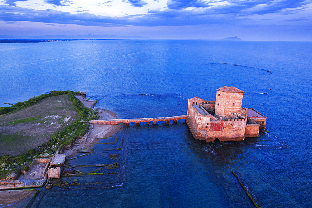 Aerial view of Torre Astura castle in the water of the Tyrrhenian Sea seen at dusk, Lazio, Italy, Europe