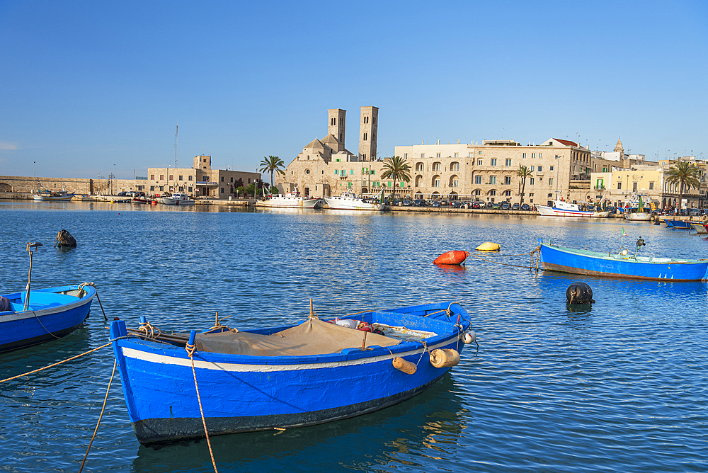 Small blue boats moored in the water of the harbour of the old medieval town of Barletta, Adriatic Sea, Mediterranean Sea, Apulia, Italy, Europe