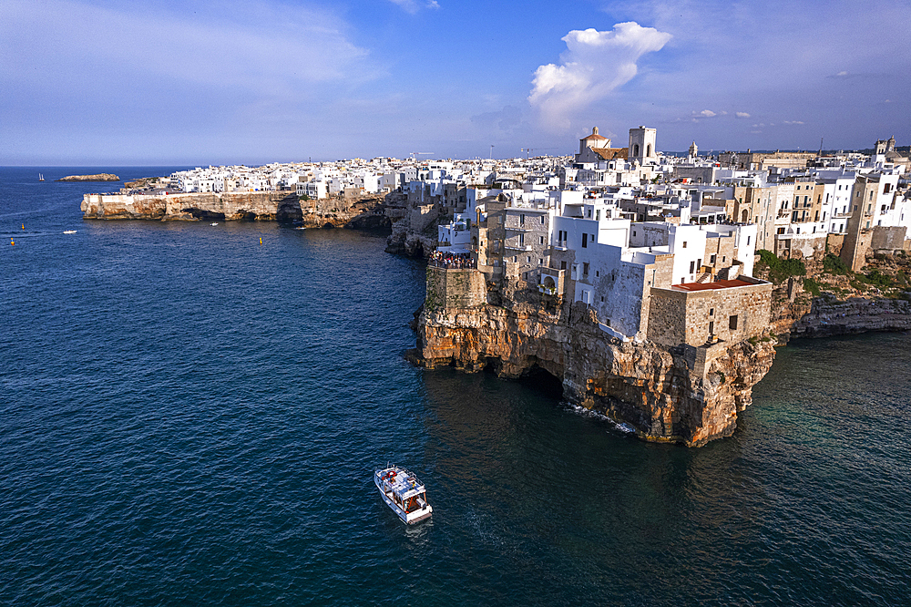 Aerial view of a boat sailing off the coast of Polignano a Mare fishing village, Bari, Apulia, Adriatic Sea, Mediterranean Sea, Italy, Europe