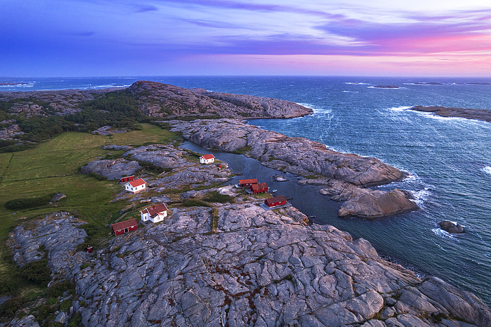 Aerial view of the scenic landscape of granite rocks with isolated houses and red cottages along the shore, Ramsvik island, Bohuslan, Vastra Gotaland, West Sweden, Sweden, Scandinavia, Europe