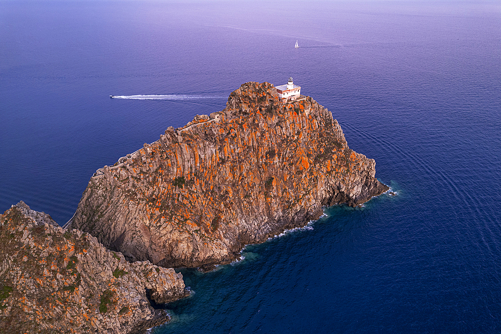 High angle view of the lighthouse of Ponza (Punta della Guardia lighthouse) on top of basalt cliff at dusk, Ponza island, Tyrrhenian Sea, Pontine islands, Latina Province, Latium (Lazio), Italy, Europe