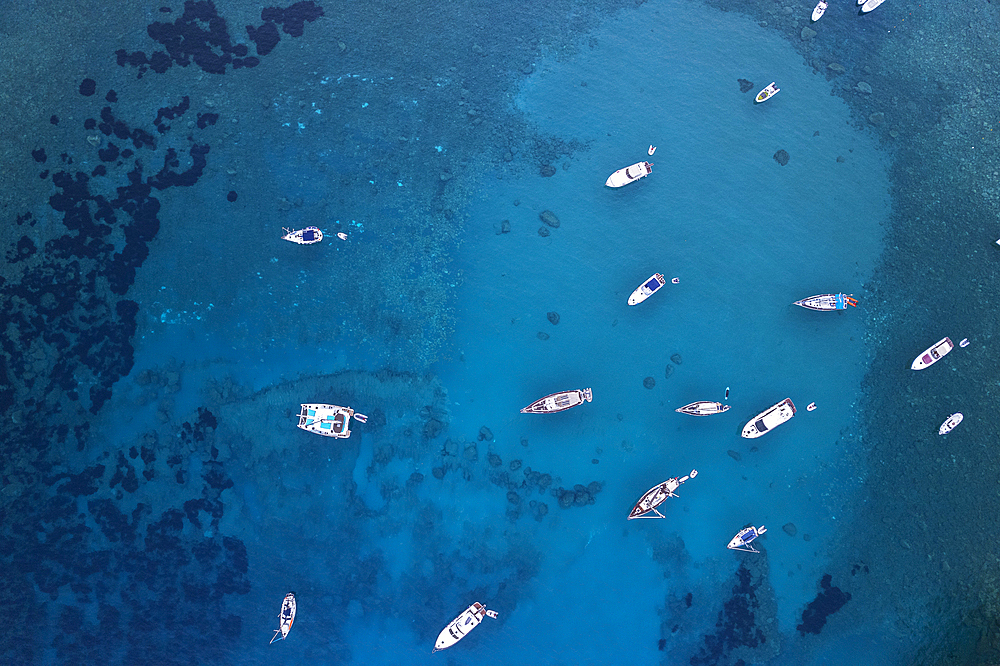 Aerial view of boats anchored in the crystal blue waters, Palmarola island, Tyrrhenian Sea, Ponza municipality, Pontine archipelago, Latina Province, Latium (Lazio), Italy, Europe