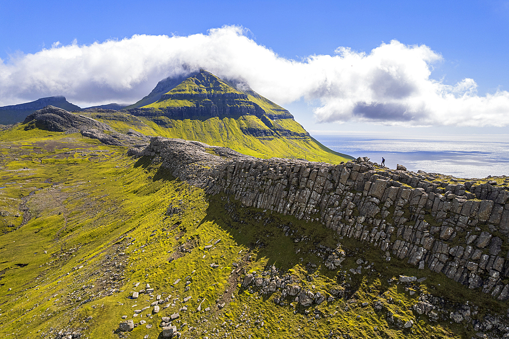 One person hikes the ridge toward the Skaelingsfjall mountain, Streymoy island, Faroe islands, Denmark, Europe