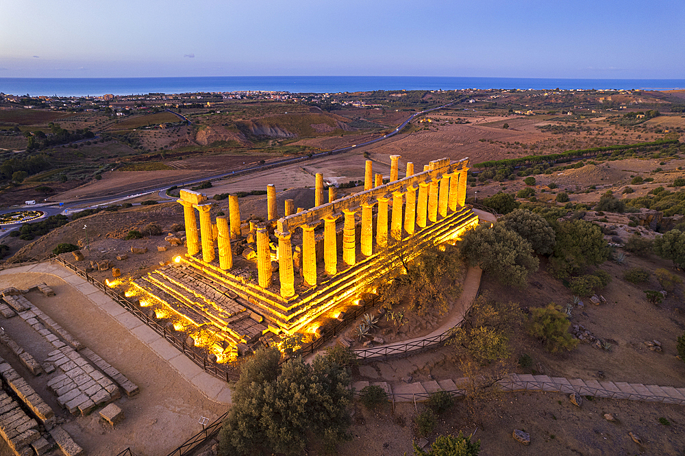 The illuminated Greek Temple of Hera seen from a drone, Valley of the Temples, UNESCO World Heritage Site, Agrigento, Sicily, Italy, Mediterranean, Europe