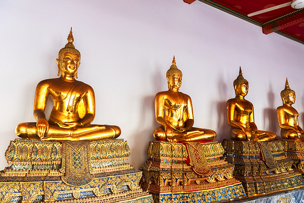 Rows of golden Buddha statues in a temple of Wat Pho, Bangkok, Thailand, Southeast Asia, Asia