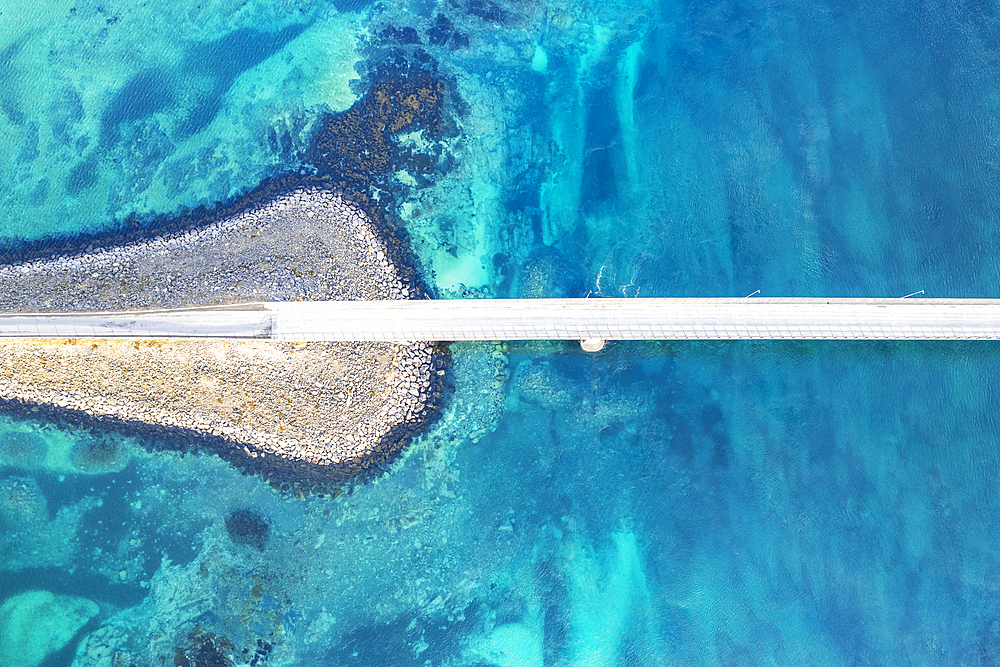 Aerial view of the bridge linking islands crossing the fjord with turquoise Arctic water, Flakstadburene, Fredvang, Lofoten Islands, Norway, Scandinavia, Europe