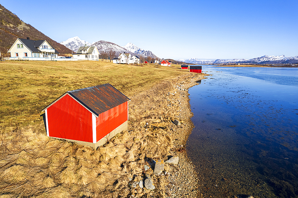 Traditional red cabins by the fjord seen in a sunny clear day, Leknes, Lofoten Islands, Norway, Scandinavia, Europe