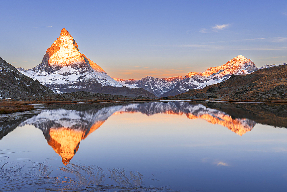 Matterhorn reflection in Riffelsee lake at sunrise, Gornergrat, Zermatt, canton of Valais, Switzerland, Europe