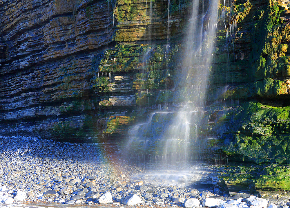 Waterfall at Cwm Bach, Traeth Bach Beach, near Southerndown, Glamorgan Heritage Coast, South Wales, United Kingdom, Europe