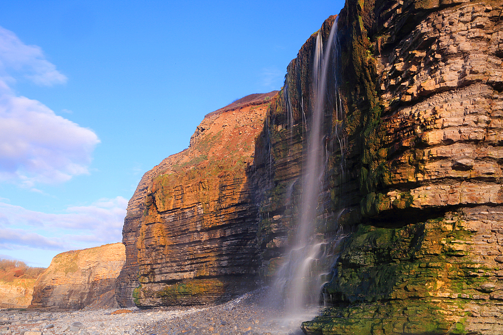 Waterfall at Cwm Bach, Traeth Bach Beach, near Southerndown, Glamorgan Heritage Coast, South Wales, United Kingdom, Europe