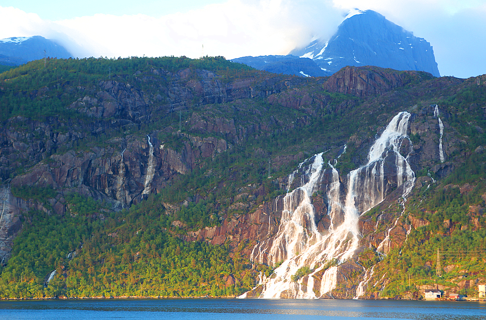 Mountains and waterfall at dawn above Nordfjord in Oldedalen Valley, near Olden, Vestland, Norway, Scandinavia, Europe