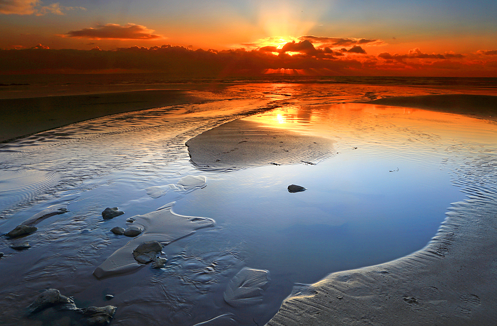 Sunset over the beach from Dunraven Bay, Southerndown, Vale of Glamorgan, South Wales, United Kingdom