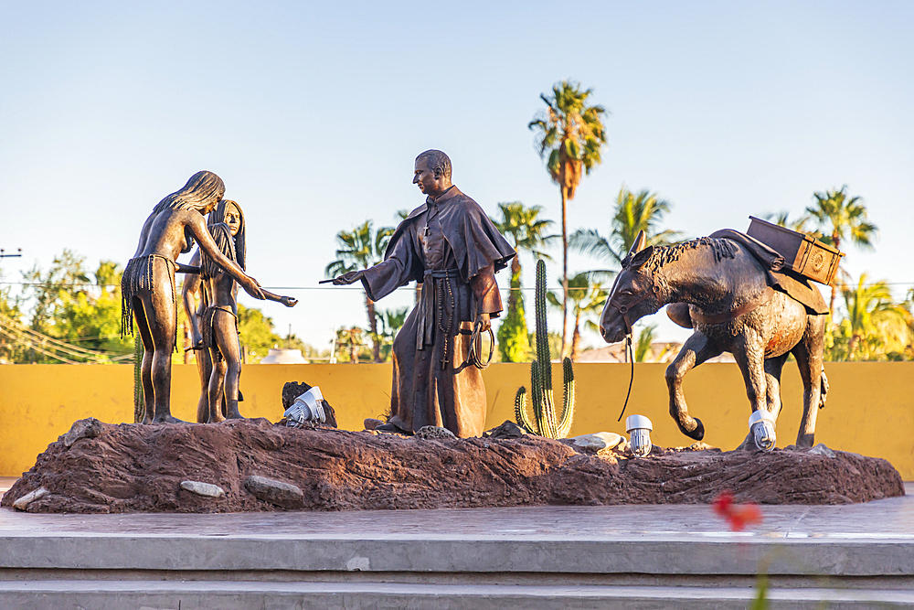 Loreto, Baja California Sur, Mexico. November 17, 2021. Sculpture of a Catholic priest interacting with indigenous Mexicans.