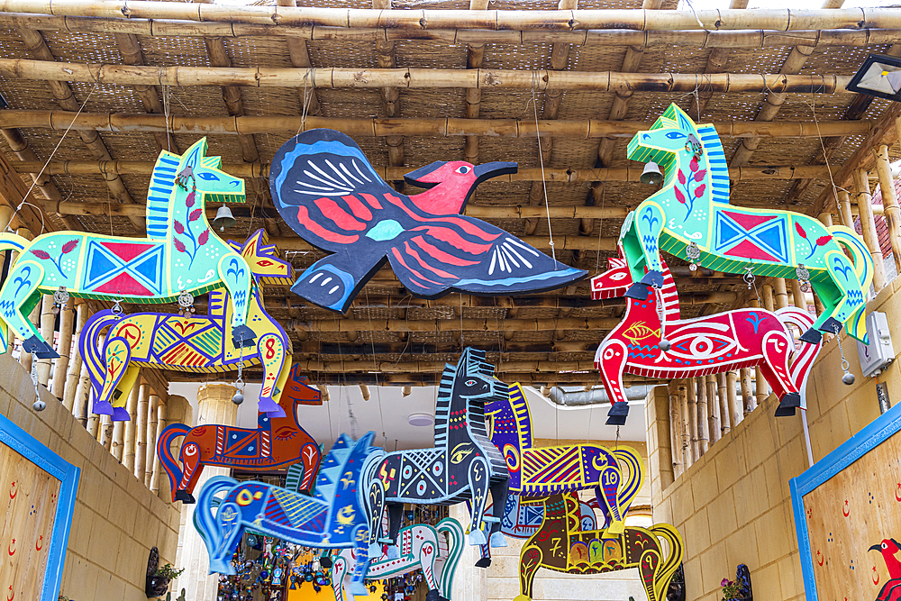 Faiyum, Egypt. February 19, 2022. Wooden painted horses and birds in the village of Faiyum.