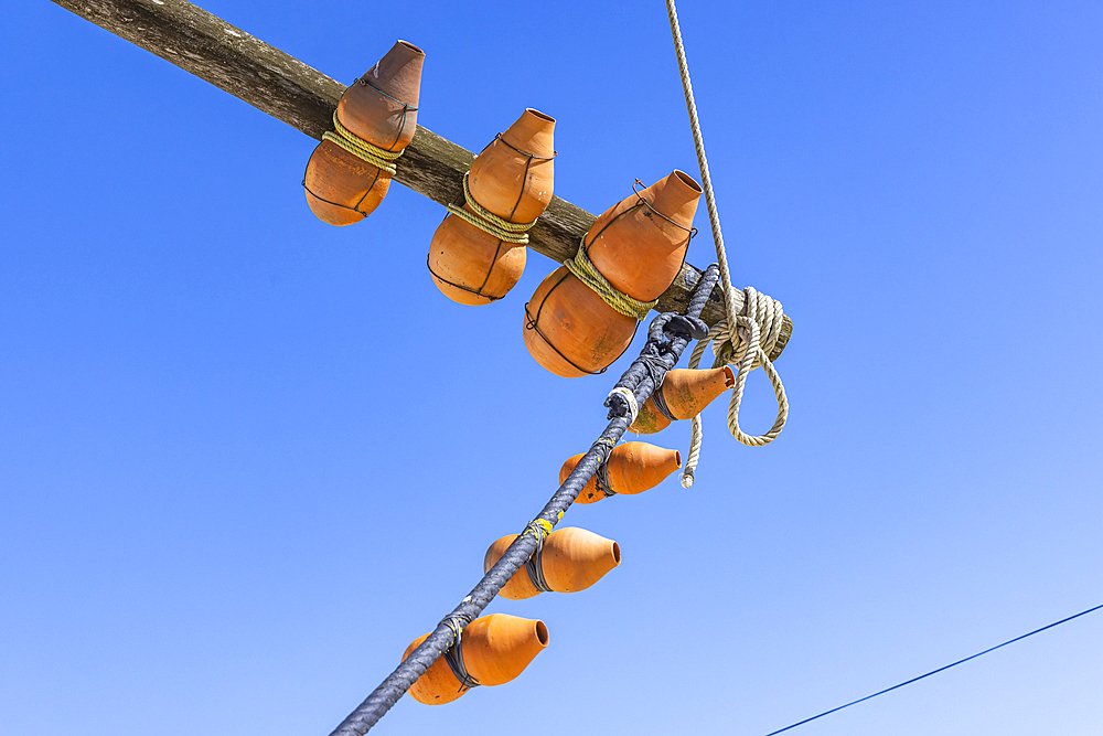 Europe, Portugal, Moita dos Ferreiros. Clay pots, known as buzio, on a traditional windmill. The sound of the wind in the buzio help the miller control the mill.