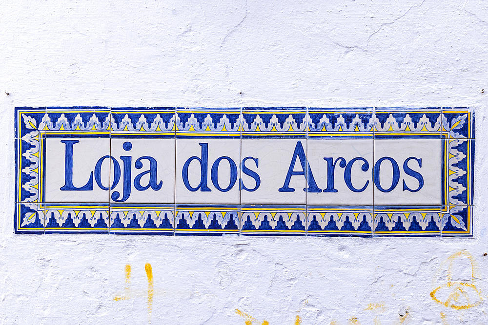 Europe, Portugal, Obidos. April 15, 2022.  Typical ceramic tiles with shop name, 'The Arches Shop.'.