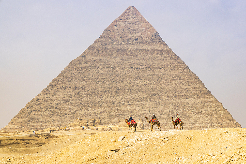 Giza, Cairo, Egypt. February 18, 2022. Men on camels at the Great Pyramid complex in Giza.