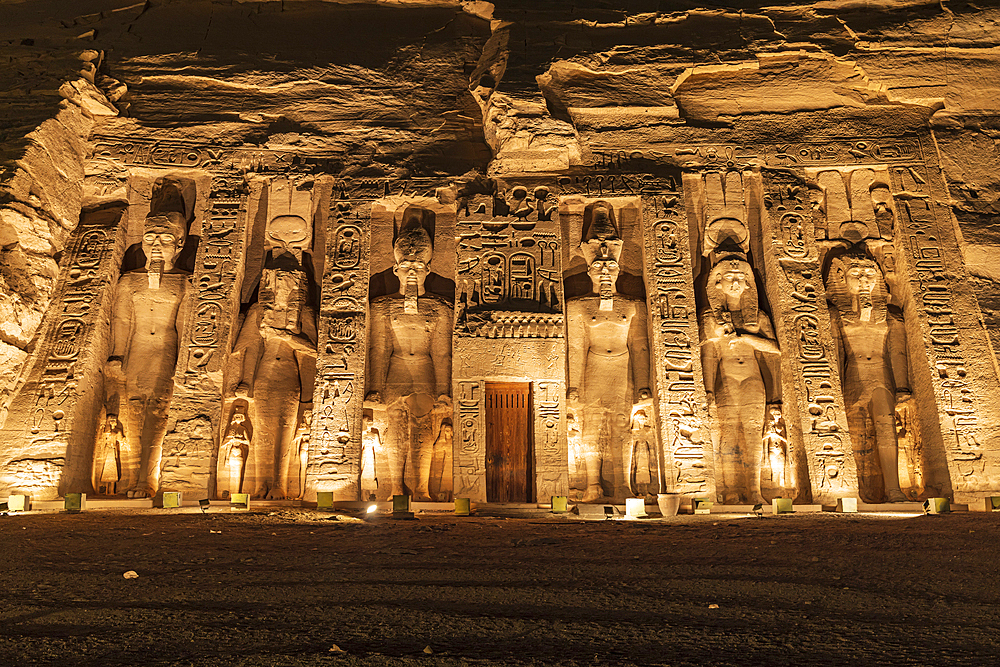 Abu Simbel, Aswan, Egypt. February 22, 2022. The colossal statues of the Small Temple of Ramesses II lit up at night.