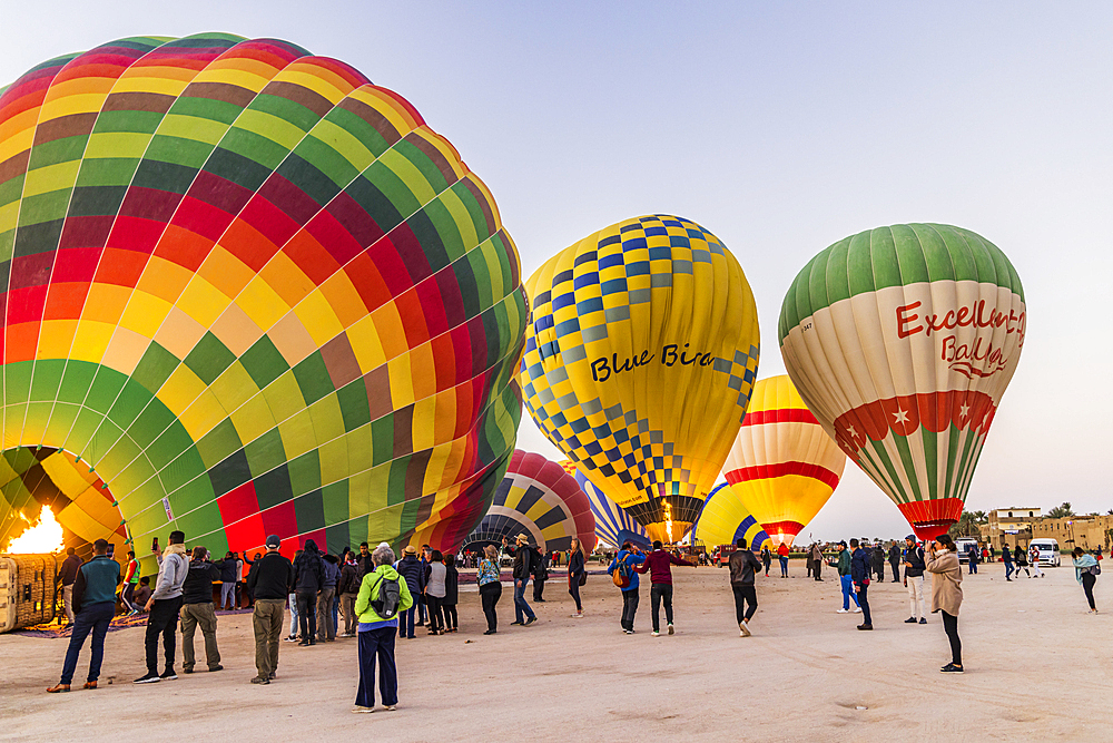 Luxor, Egypt. February 26, 2022. Hot air balloons being prepared for tourist rides at sunrise in Luxor.