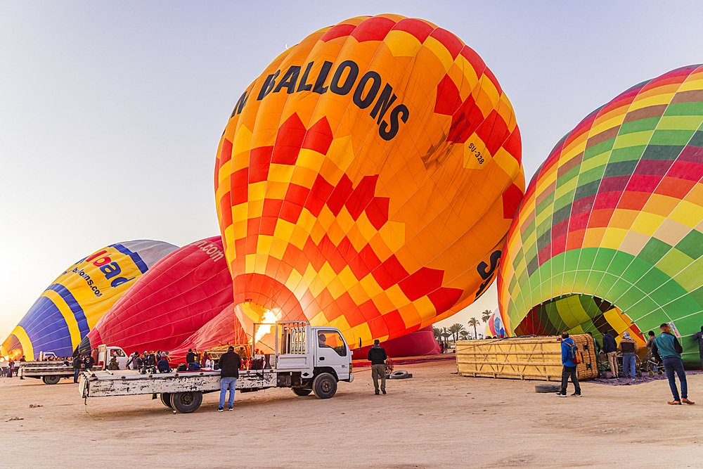 Luxor, Egypt. February 26, 2022. Hot air balloons being prepared for tourist rides at sunrise in Luxor.