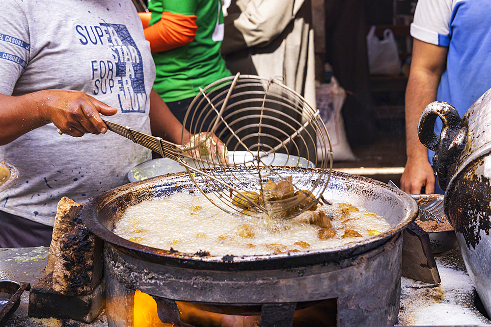 Thebes, Luxor, Egypt. February 24, 2022. Vendor frying falafel balls in oil.