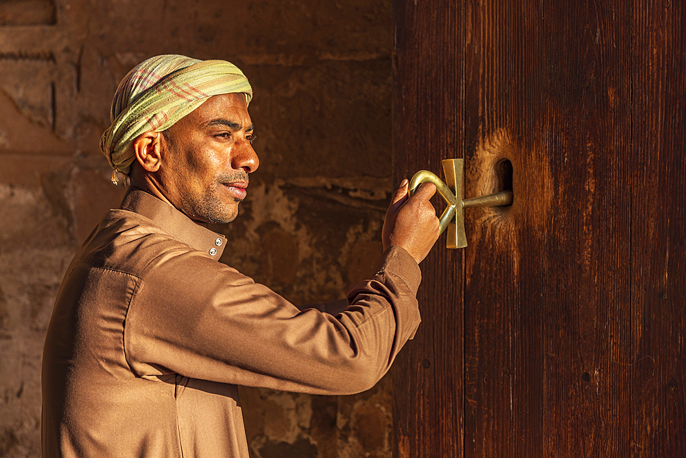 Abu Simbel, Aswan, Egypt. February 23, 2022. Caretaker holding a large key in the shape of an Ankh in the Great Temple of Ramesses II.