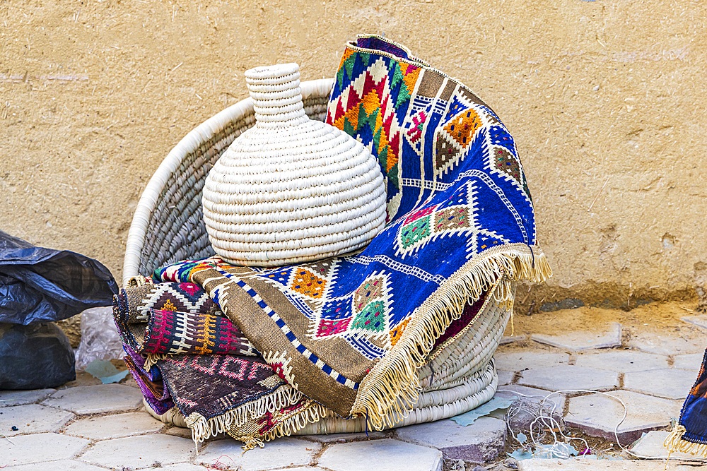 Faiyum, Egypt. Woven basket and a colorful blanket in the village of Faiyum.