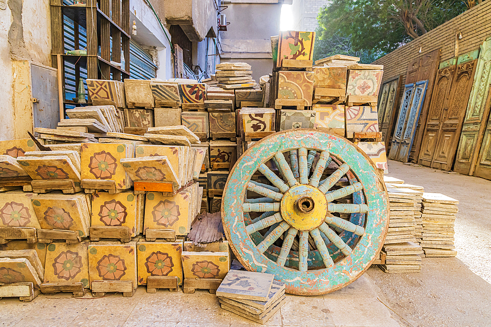 Old Cairo, Cairo, Egypt. Wooden cart wheel and floor tiles in an alley in Cairo.