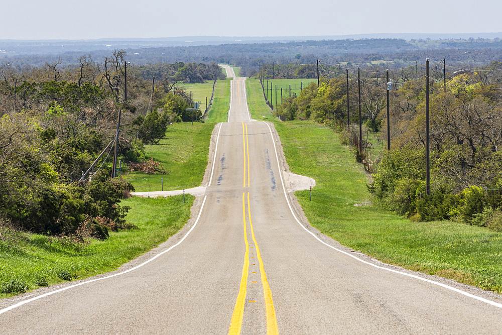 Johnson City, Texas, USA. An empty country road in the Texas hill country