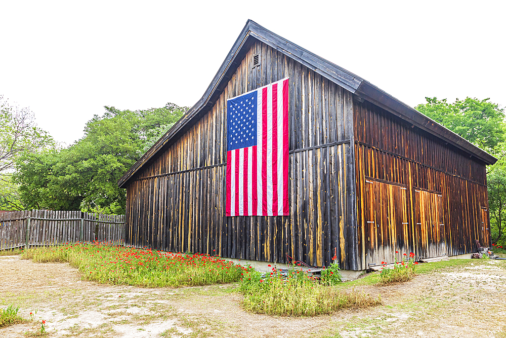 Castroville, Texas, USA. April 12, 2021. Large American flag on a barn in the Texas hill country.