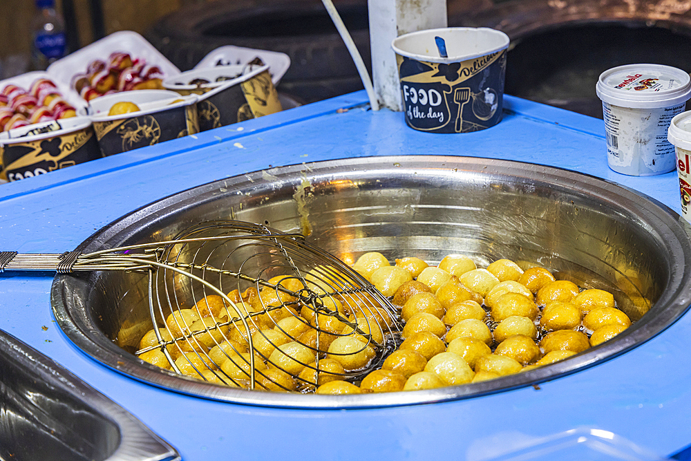 Cairo, Egypt.. February 18, 2022. Falafel balls being cooked at a shop on El Moez street in Old Cairo.