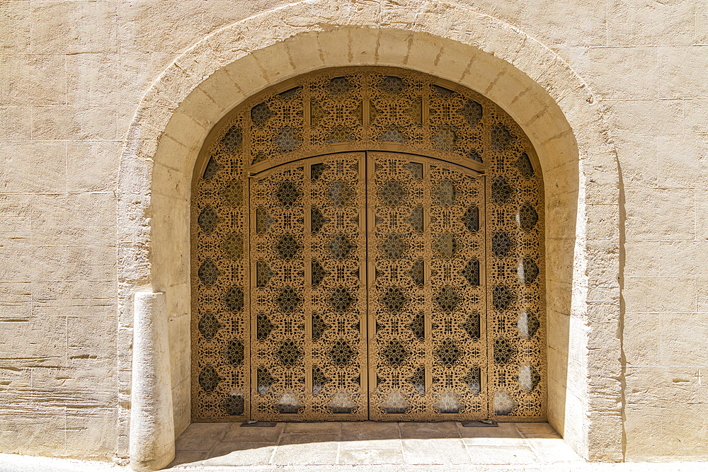 Arles, Bouches-du-Rhone, Provence-Alpes-Cote d'Azur, France. Ornate metal grill over a doorway in Provence.