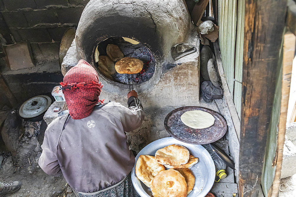 Margib, Sughd Province, Tajikistan. August 15, 2021. Baking flat bread in a traditional wood fired oven. Editorial Use Only