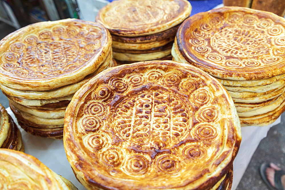 Khujand, Sughd Province, Tajikistan. Flat bread for sale at the Panjshanbe Bazaar in Khujand.