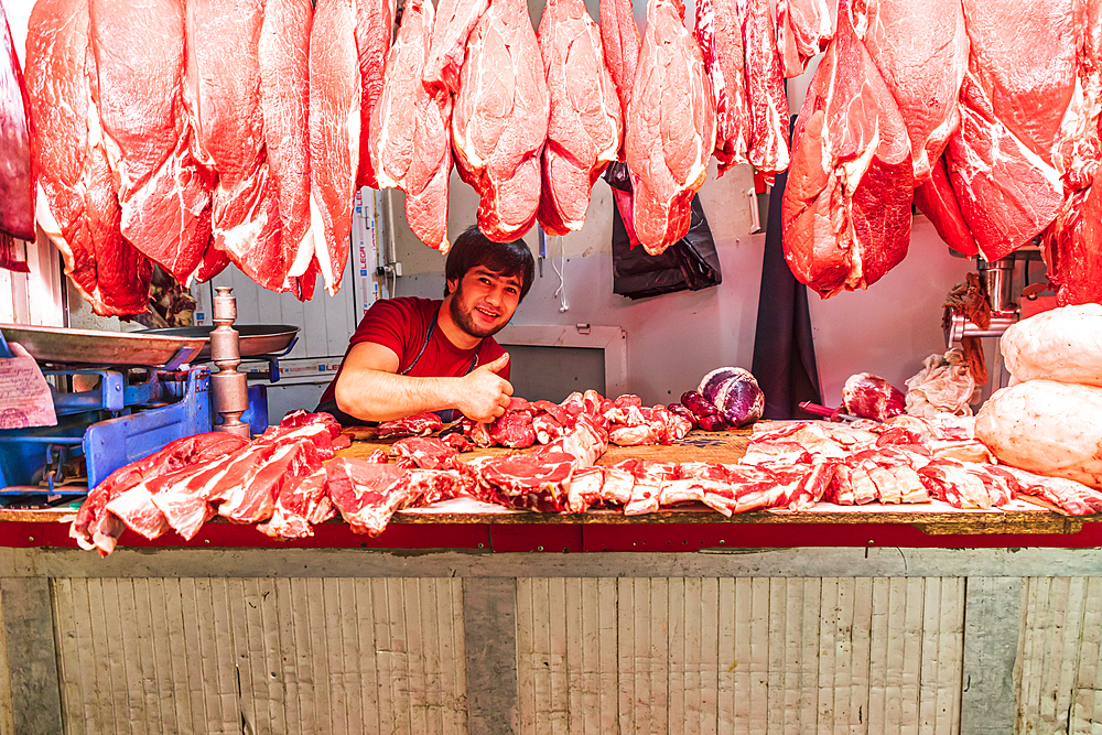 Khujand, Sughd Province, Tajikistan. August 20, 2021. Butcher selling meat at the Panjshanbe Bazaar in Khujand. Editorial Use Only