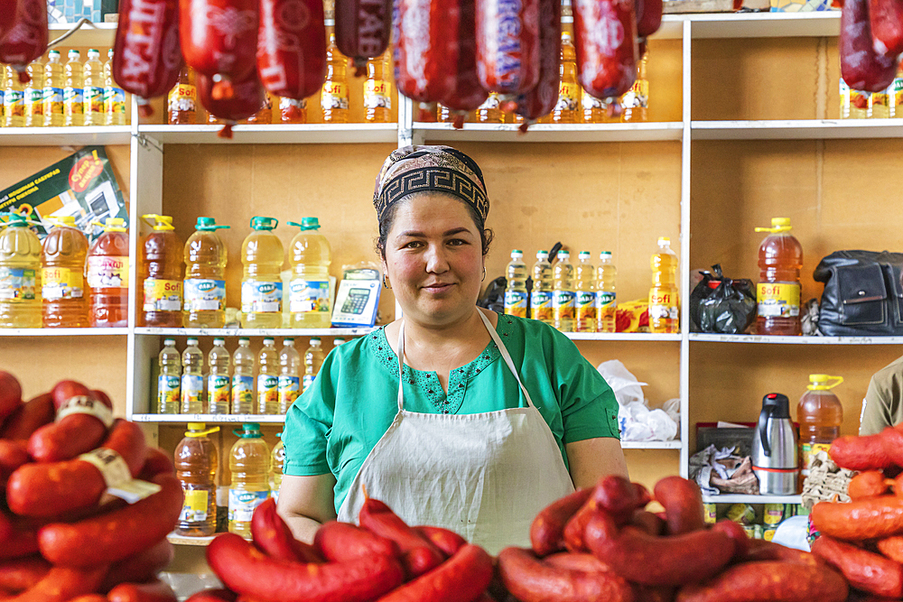 Khujand, Sughd Province, Tajikistan. August 20, 2021. Woman selling sausages at the Panjshanbe Bazaar in Khujand. Editorial Use Only