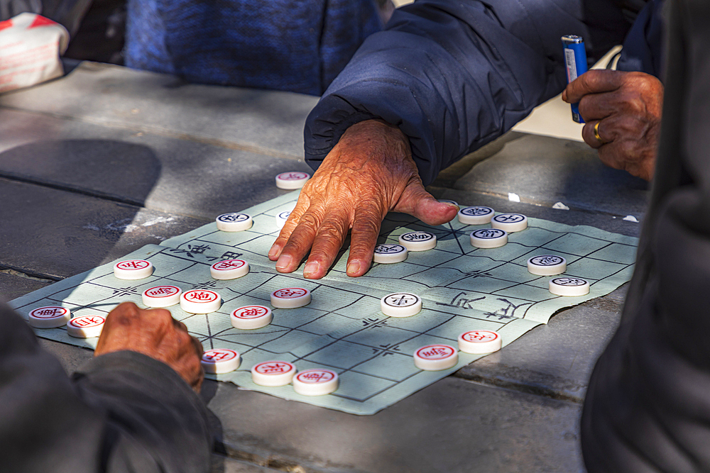 Chinatown, Manhattan, New York City, New York, USA. People playing Chinese Chess in Columbus Park.