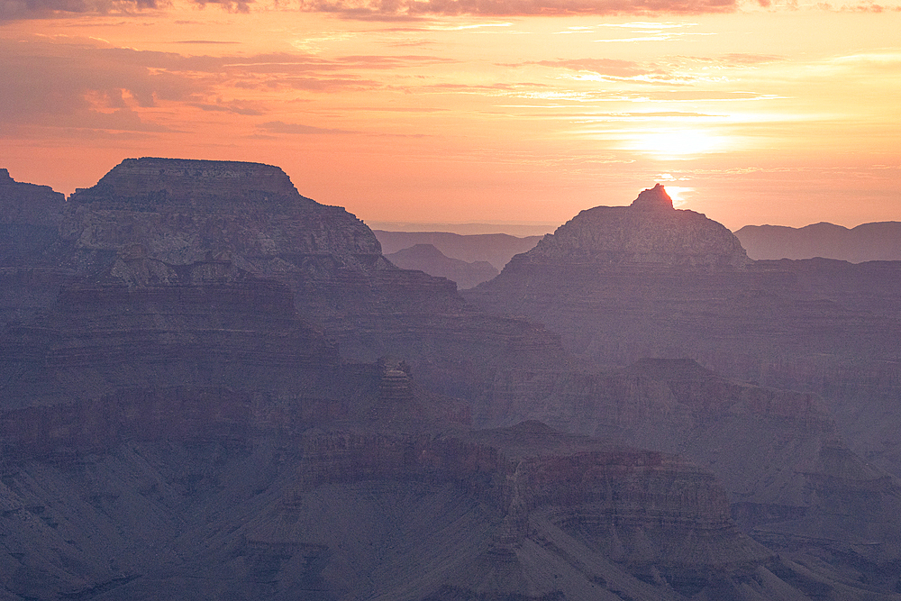 Golden light envelops the Grand Canyon during a summer sunrise, Tusayan, Arizona, United States of America, North America