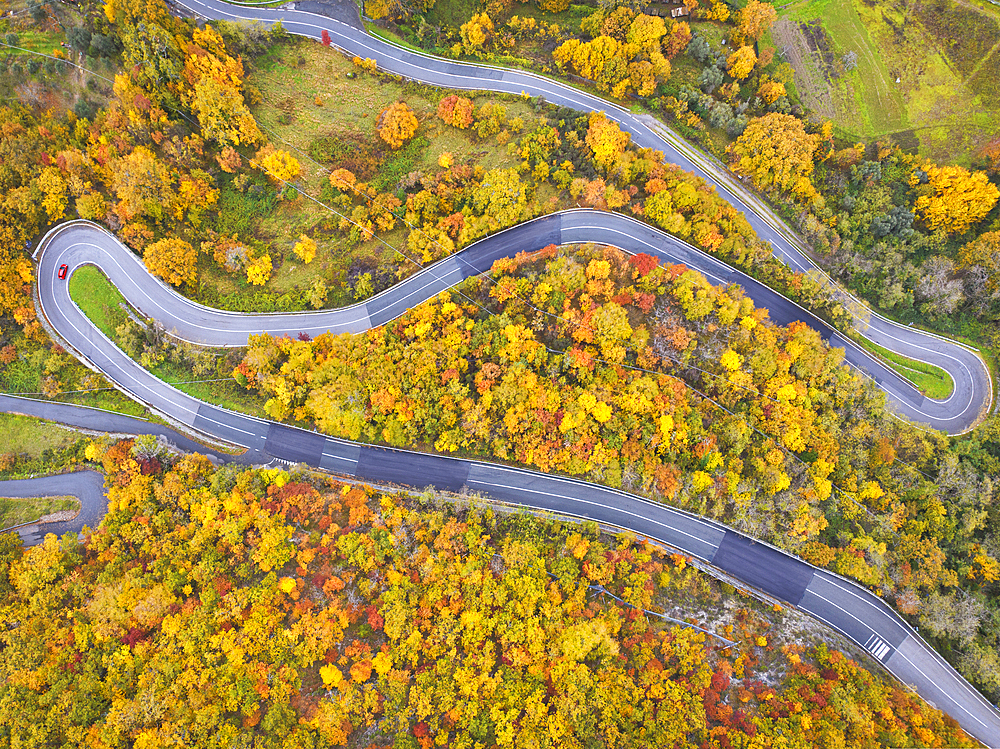 A car driving along the mountain road on an autumn day, Tuscan-Emilian Apennine National Park, Tuscany, Italy, Europe