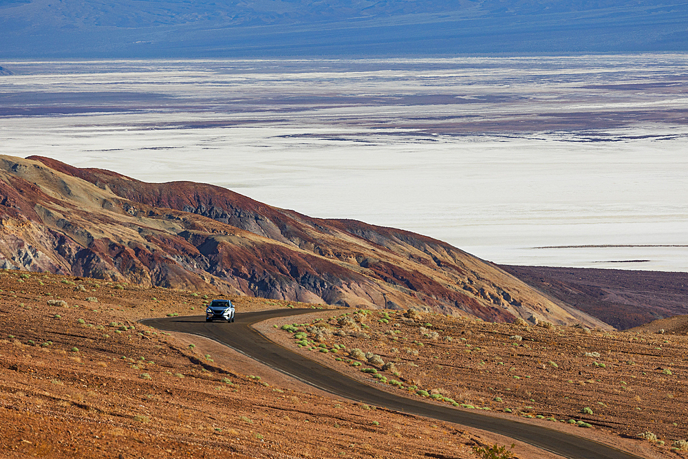 a car drive through the road in Death Valley, California, United States of America