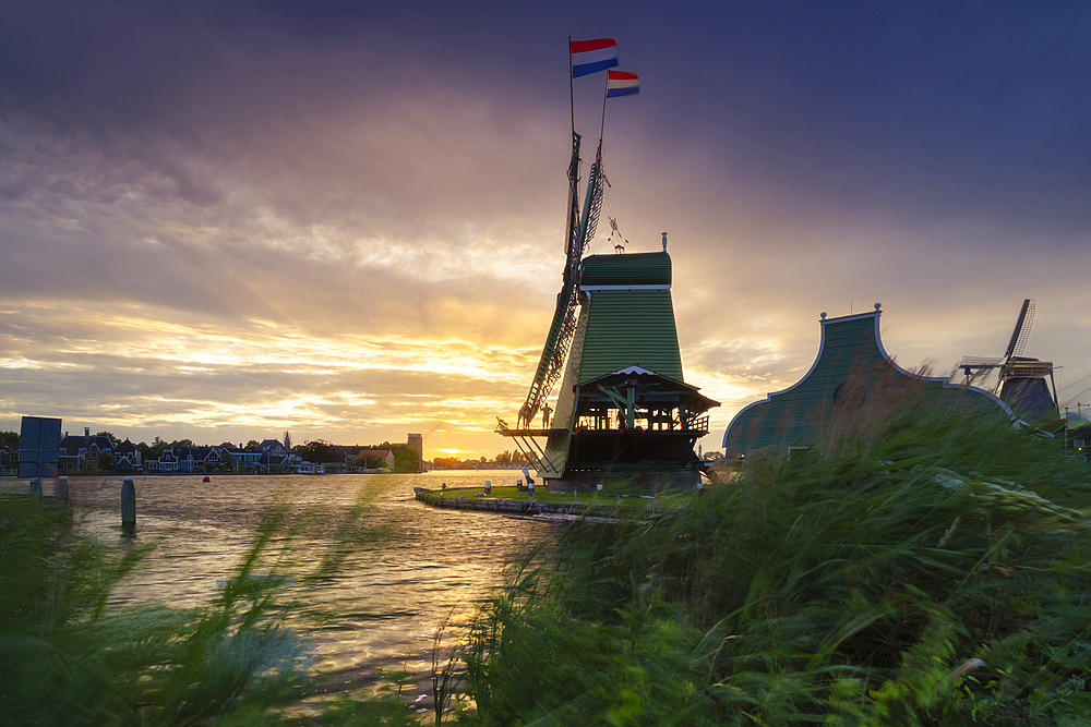 A windmill at Zaanse Schans during sunset in summer, Zaanstad, Zaandam, Netherlands, North Holland, Western Europe