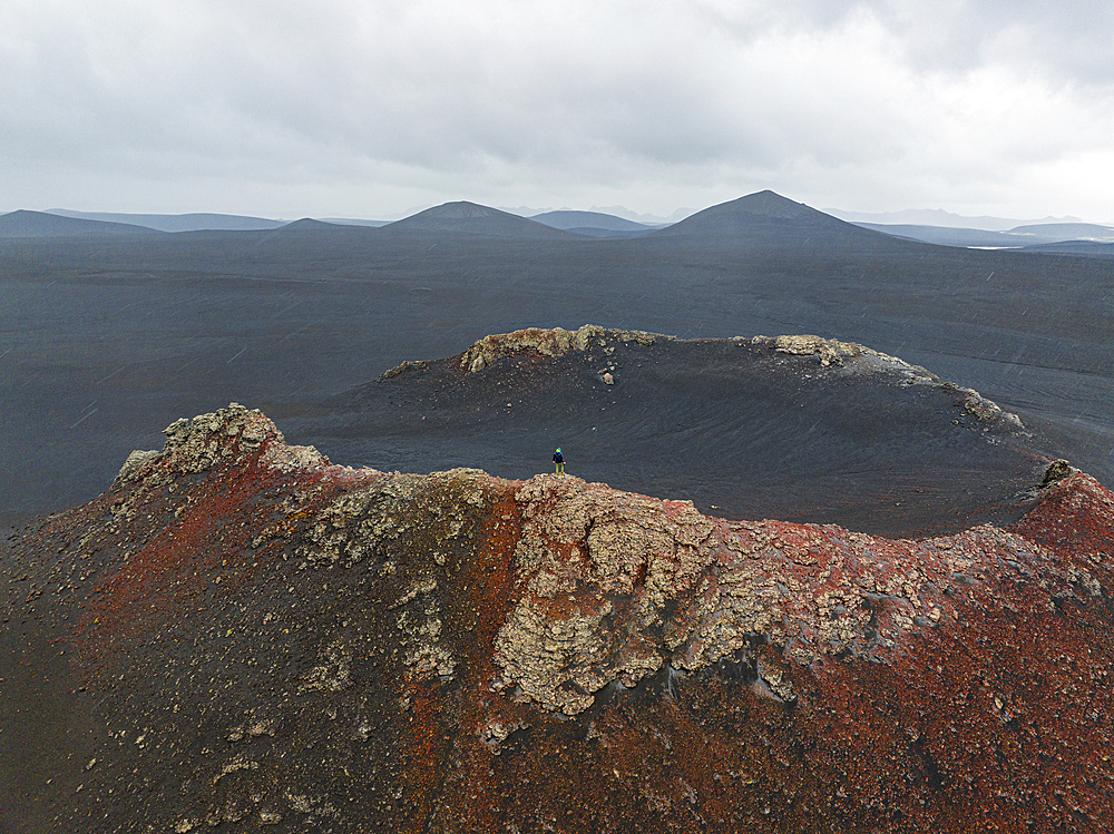 A person enjoy the beautiful landscape from the mouth of old volcano, Highlands, Iceland, Polar Regions