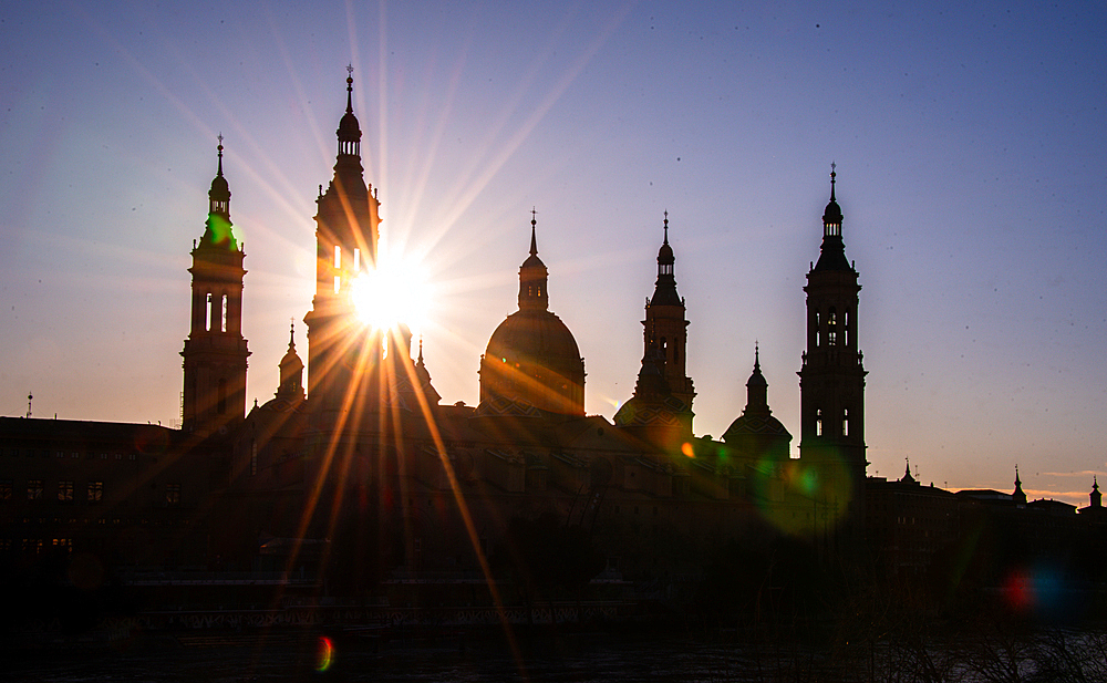 Silhouette sunset of Basilica of Our Lady of the Pillar and the River Ebro, Zaragoza, Aragon, Spain.