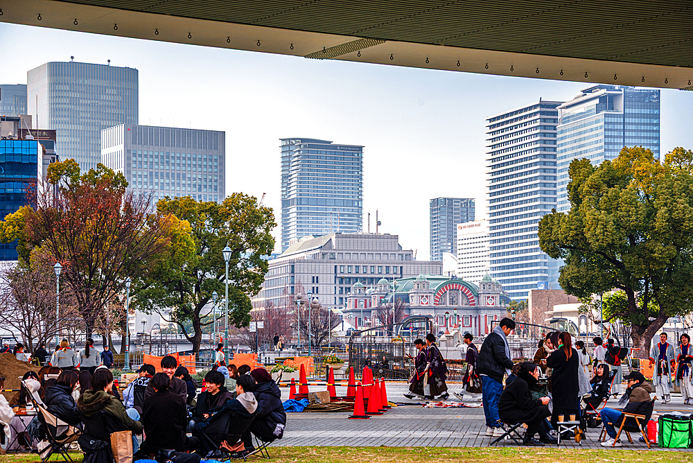 Nakanoshima in Osaka, Japan. A green Island park in the center of Osaka. People spending their free time under a highway bridge on Nakanoshima park