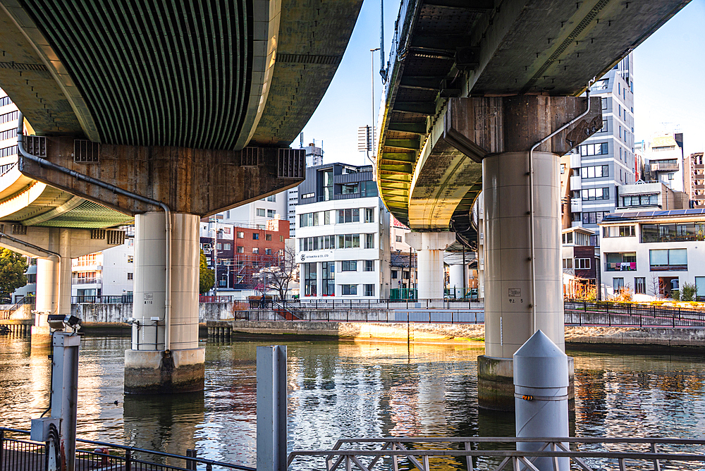 Nakanoshima in Osaka, Japan. A green Island park in the center of Osaka. Highway bridges over Dojima River in Osaka.