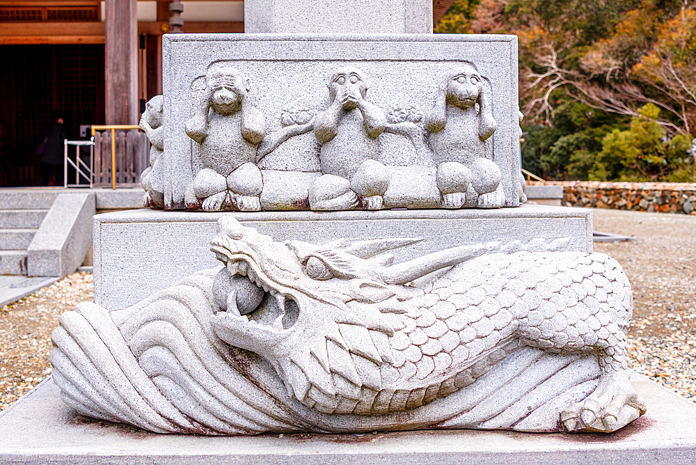 Stone statue of the Three wise monkeys on a dragon at Minoh National Park near Osaka,Kansai Japan