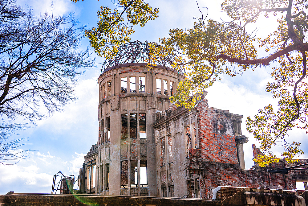 Hiroshima, Japan. Atomic Bomb Dome with lush trees in front of it