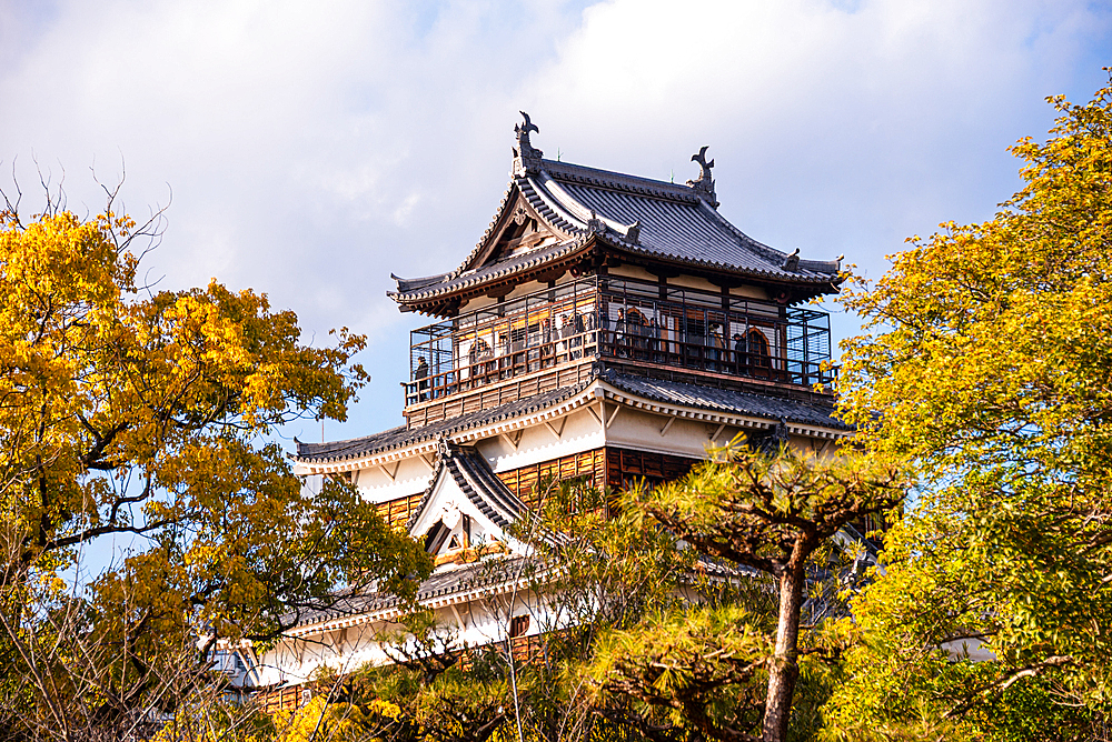 Hiroshima Castle main tower in yellow autumnal leaves. Hiroshima, Japan,