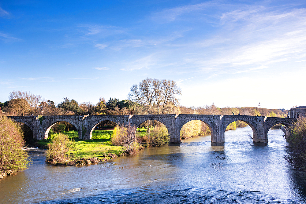 Arched stone bridge Pont Vieux in river Aude. Medieval castle of Carcassonne, Languedoc-Roussillon, France